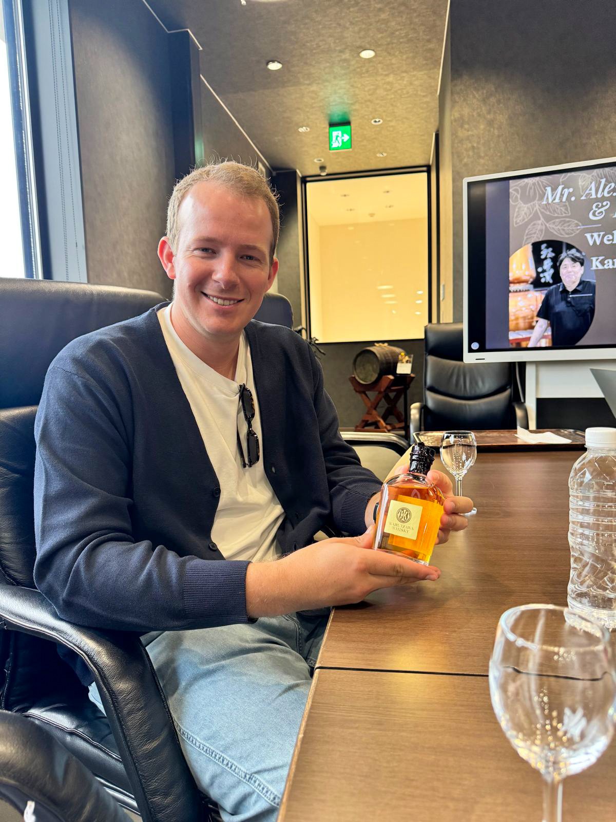 A dekantā client holding a bottle of Karuizawa whisky